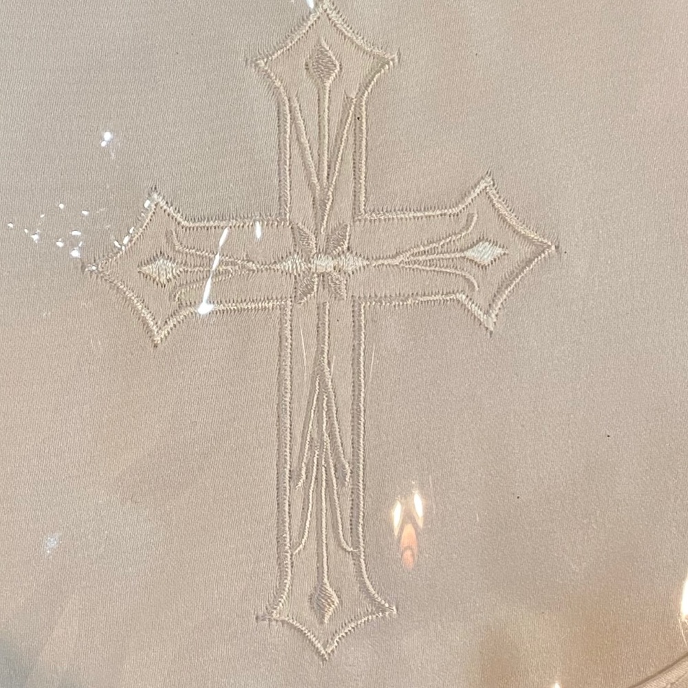 Bib with embroidered cross